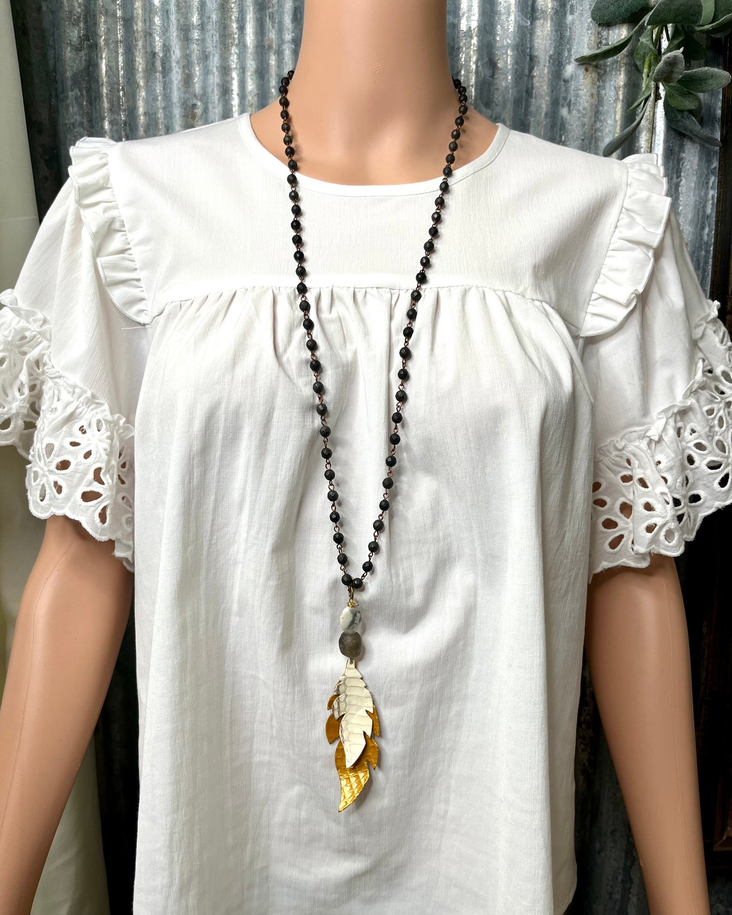 Black Beaded Necklace with Mustard Leather Feather Pendant