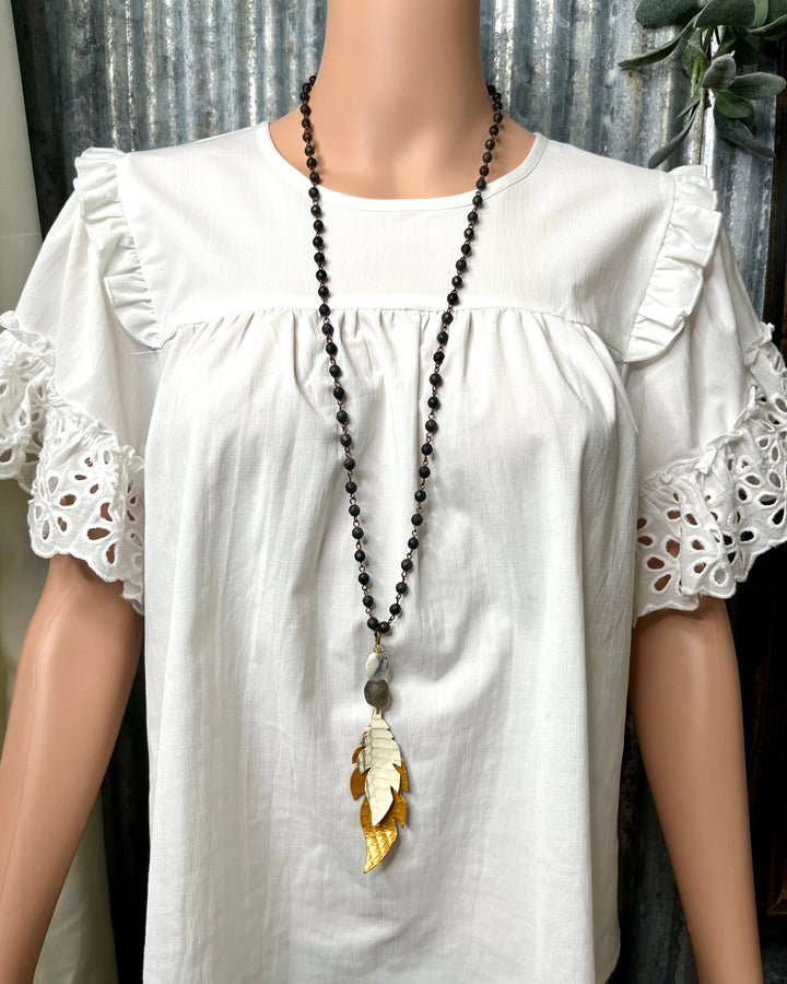Black Beaded Necklace with Mustard Leather Feather Pendant